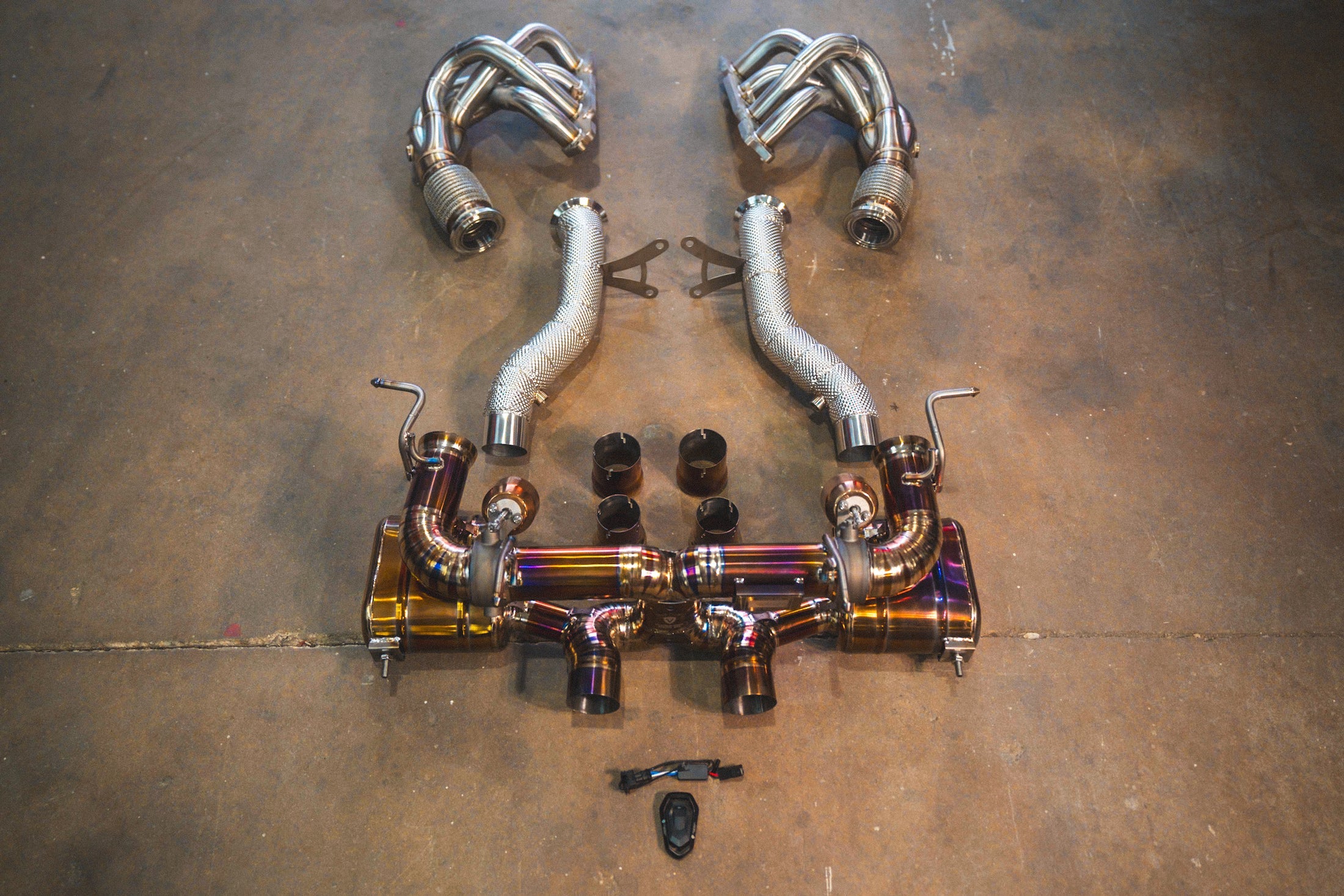 Mumani motorwerks titanium exhaust suite with colored pipes and mufflers