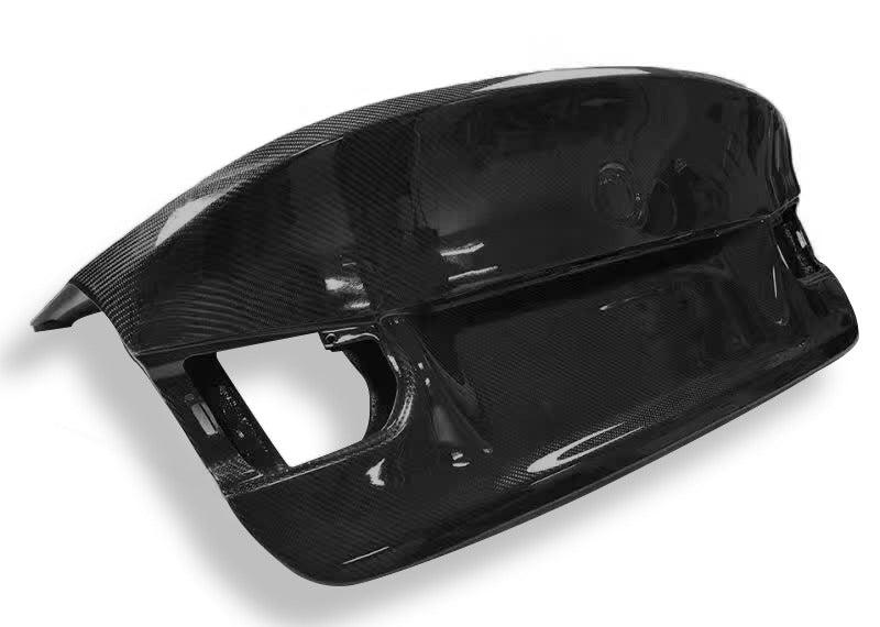 Sleek carbon fiber rear trunk bumper in metallic or plastic finish