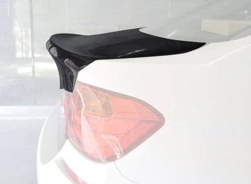 Sleek carbon fiber rear trunk bumper in metallic or plastic finish