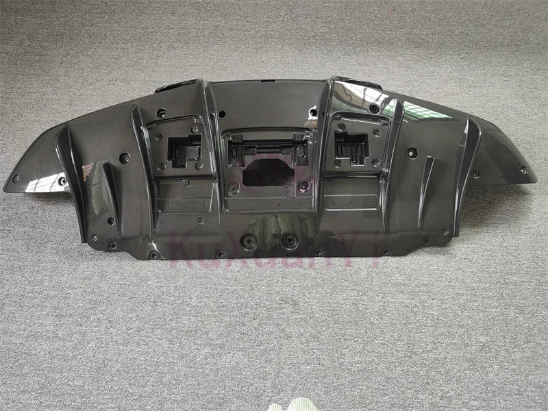 Car underbody panel with aerodynamic diffuser and trim pieces